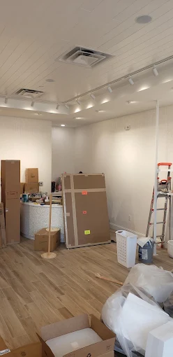 Interior shop space with track lighting and recessed cans