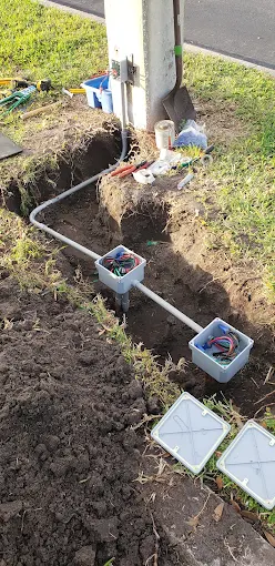 Conduit and junction boxes set at a pole base